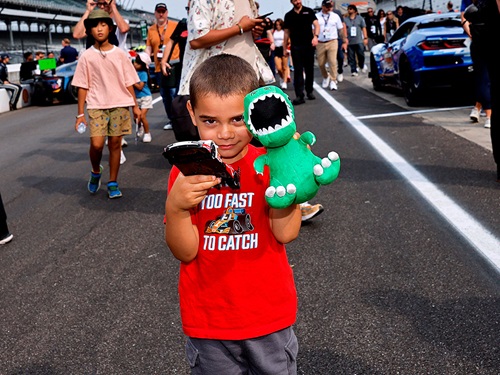 A child shows off his toys
