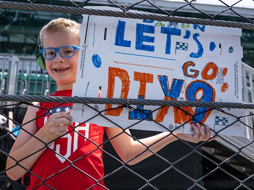 A young fan roots for Scott Dixon
