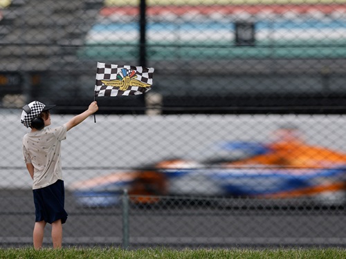 A child watches cars on the track at Indianapolis Motor Speedway.