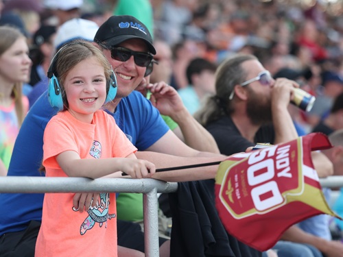 A father and daughter in the stands at the Indianapolis Motor Speedway.