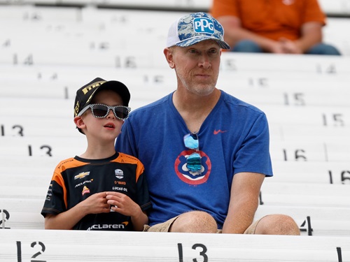 A father and son in the stands at Indianapolis Motor Speedway.