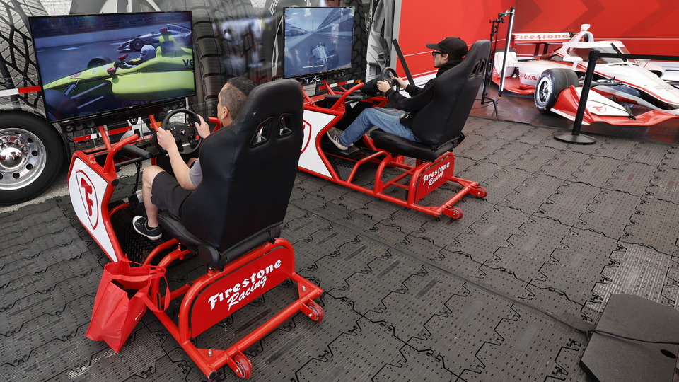 Fans race on a simulator at the Fan Midway.