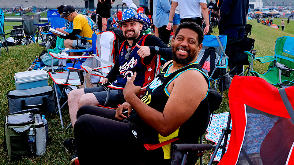 Two men sit in general admission