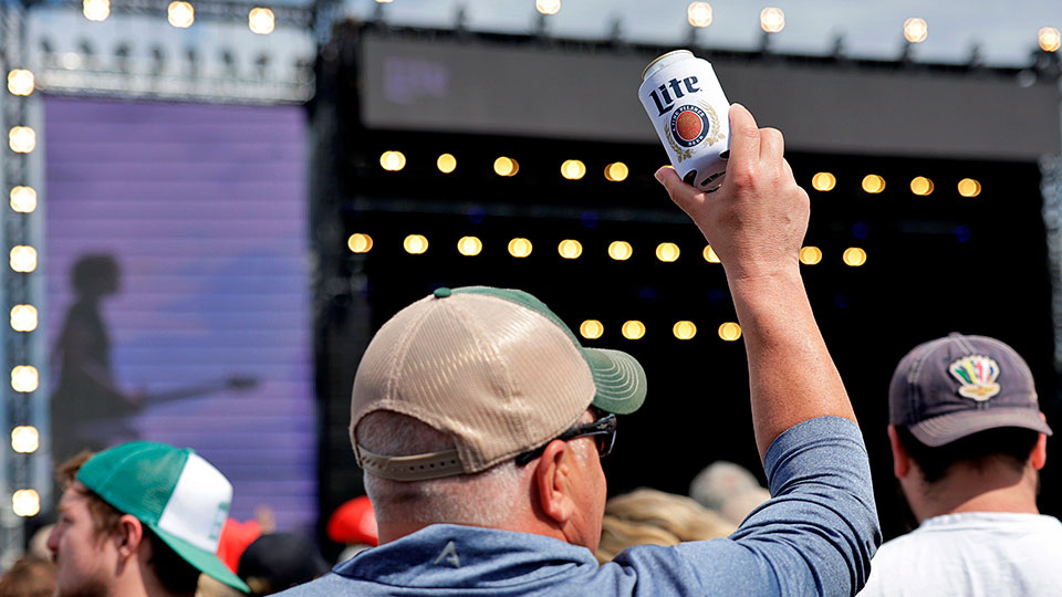 A man with a Miller Lite watches the Carb Day Concert