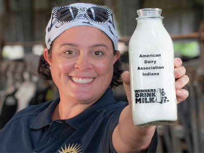 Jill Houin shows off a bottle of milk