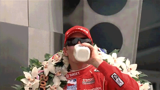 Scott Dixon celebrating in Victory Lane with a bottle of milk